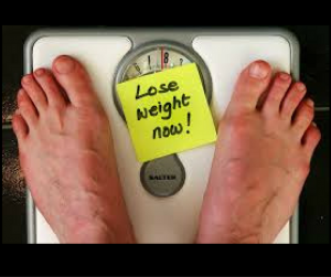 man stepping on a scale, must lose weight, judge weight